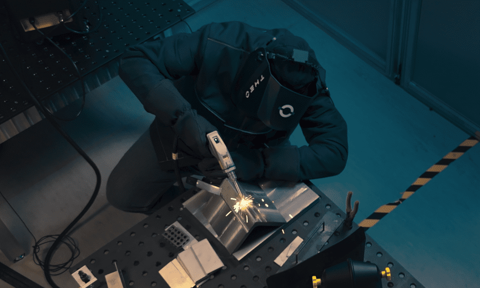 Welder sitting at a safe welding table covered in PPE