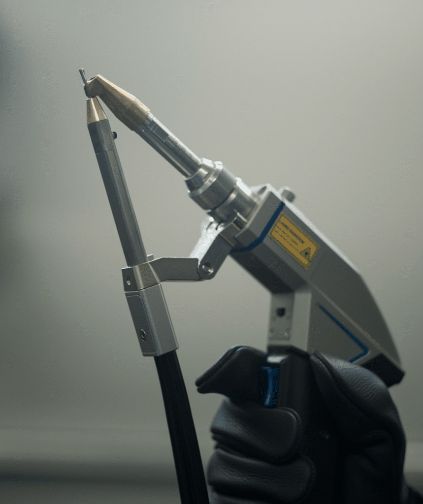 hand holding agains a gray background a laser welding torch